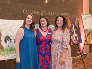 Picasso Pets 2022 Guests, including Brittany Filby, pose in front of artwork at the 2022 Picasso Pets gala.