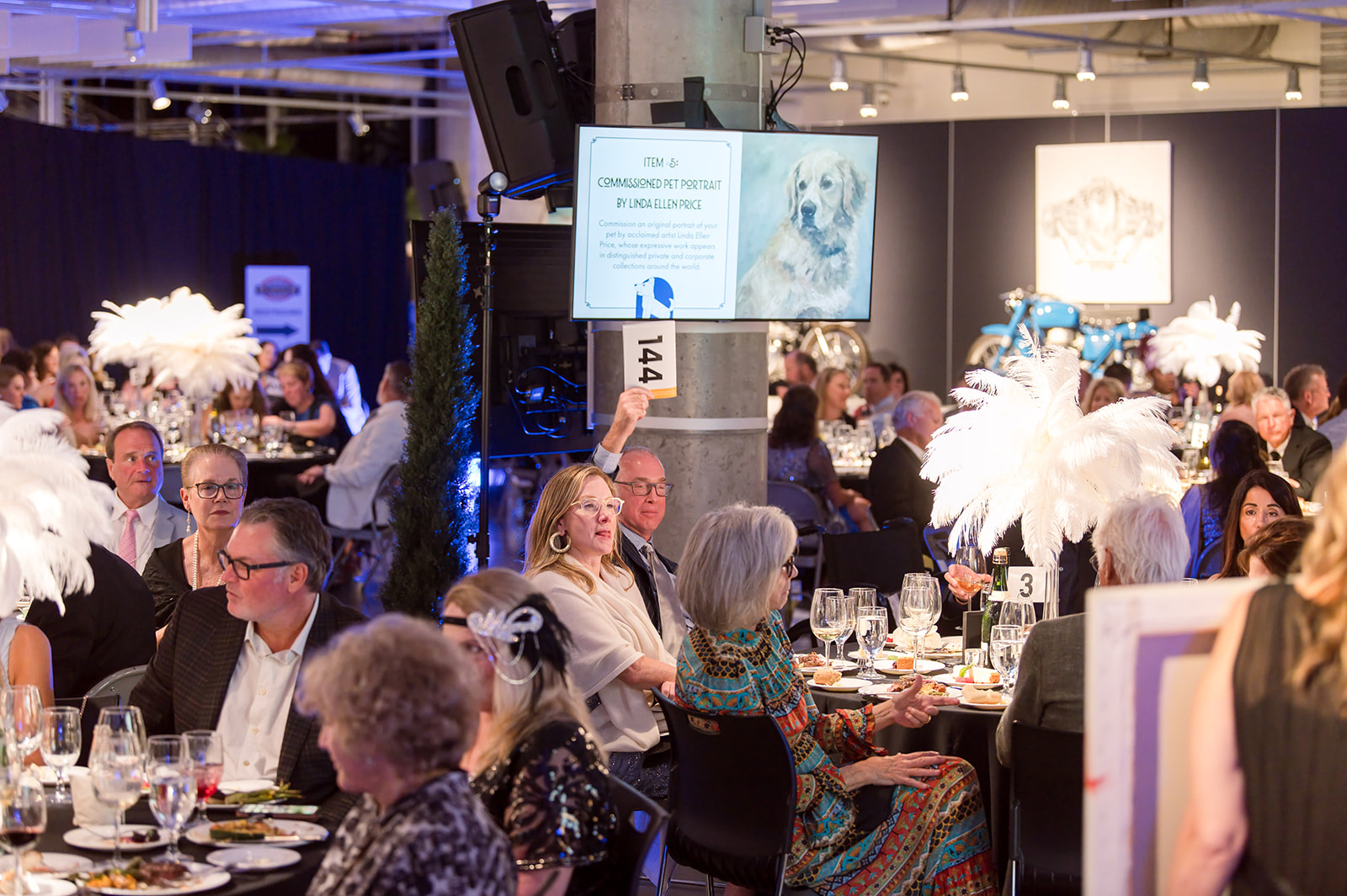Guests celebrate at Hand in Paw's Picasso Pets 2026 gala at Barber Vintage Motorsports Museum.