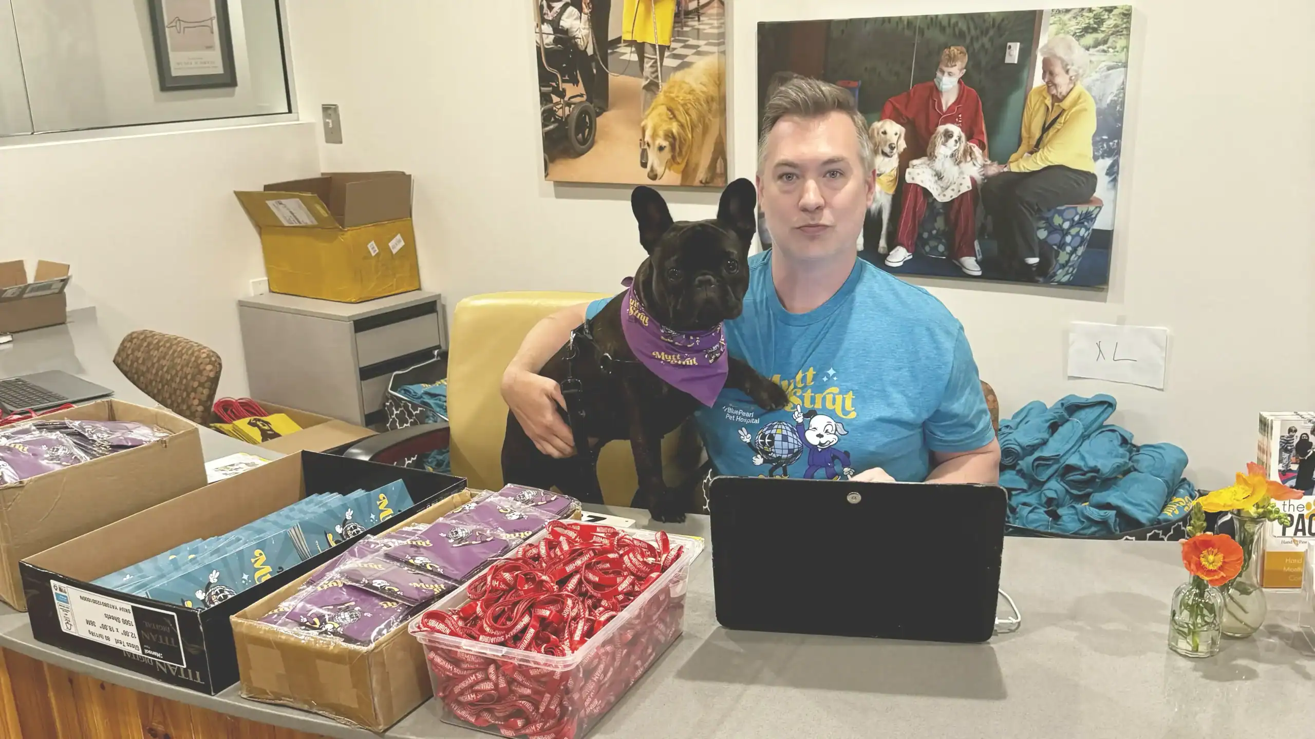 Michael Hansen and Hugo sit at the reception desk at the Hand in Paw office